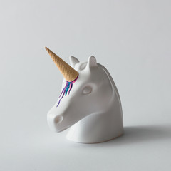 White painted unicorn head with colorful ice cream horn on bright white background. Minimal art fantasy concept. Summer fairytale. © Zamurovic Brothers