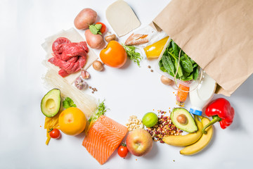 Grocery shopping concept. Balanced diet concept. Fresh foods with shopping bag on white background