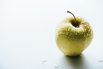 close up view of fresh green apples with water drops on white background