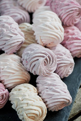 A lot of marshmallow in pastel shades of pink, purple. Confectionery art. Banquet or birthday