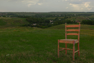 chair on green grass cloudy sky in summer background village