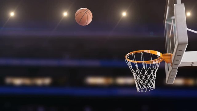 Beautiful Professional Throw in a Basketball Hoop Slow Motion. Ball Flying Spinning into Basket Net at Basketball Court with Spotlights. Sport Concept. 3d Animation 4k Ultra HD 3840x2160.
