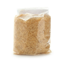 Fototapeta na wymiar Packing with long grain rice on white background