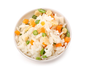 Bowl with tasty boiled rice and vegetables on white background