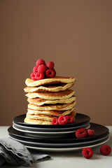 Plates with tasty homemade pancakes and berries on table