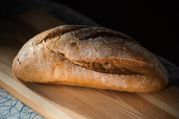 Healthy organic homemade bread on wooden table.