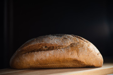 Healthy organic homemade bread on wooden table.