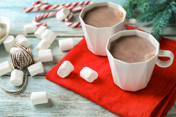 Composition with cups of tasty cocoa and marshmallows on wooden background