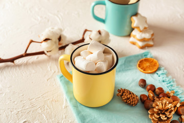 Obraz na płótnie Canvas Cup of tasty cocoa, marshmallows and Christmas decor on light background