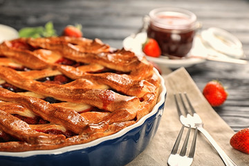 Tasty pie with berries on table
