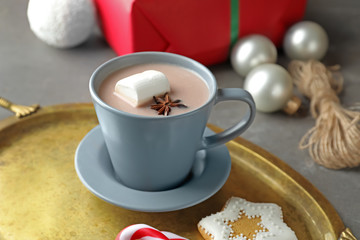 Cup of delicious hot cocoa on metal tray