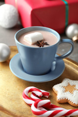 Cup of delicious hot cocoa on metal tray