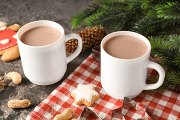 Cups of delicious hot cocoa on table