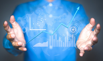 Analyzing a business analytics, Business Intelligence, Key Performance Indicators on a digital screen interface in hand of businessman.