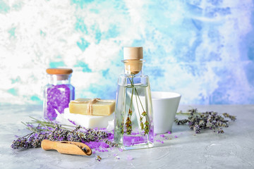 Obraz na płótnie Canvas Bottle of essential oil with lavender on table