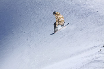 Flying snowboarder on mountains. Extreme winter sport.