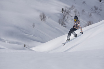 Flying snowboarder on mountains. Extreme winter sport.