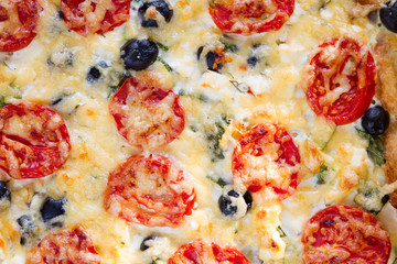 Textur of vegetarian salt pie, Quiche with tomatoes, olives and feta cheese, top view.