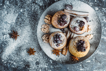  fruit dessert baked  apples stuffed with blackberry, blueberries, cinnamon, nuts, honey. Autumn or winter dessert. Top view