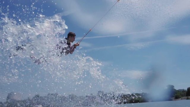 a young guy is riding a hydrocycle on the lake