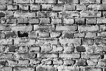 Grungy weahered brick wall in black and white.