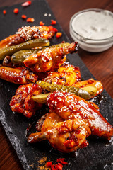American cuisine, fried chicken wings barbecue in glaze sauce. The concept of American street food.