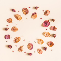 Autumn composition. Wreath made of dried flowers and leaves on pastel beige background. Autumn, fall concept. Flat lay, top view, copy space, square