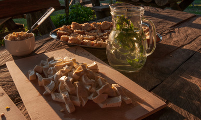 Dinner on the table, cheese, water under the sun rays 