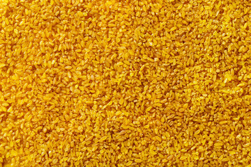 Macro image of bulgur grains as natural vegan food background. Top view