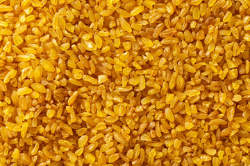 Macro image of bulgur grains as natural vegan food background. Top view