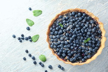 Delicious blueberry pie on table, top view