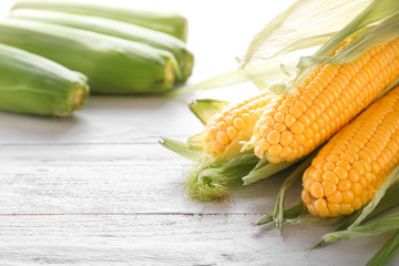 Tasty corncobs on wooden table