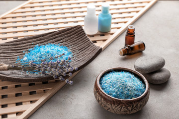 Obraz na płótnie Canvas Sea salt for spa, essential oil and lavender on table