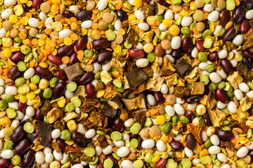 Macro image of beans and peas mix with dried eggplants as natural vegan background.