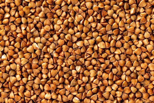 Macro image of buckwheat grain as a natural vegan food background. Top view