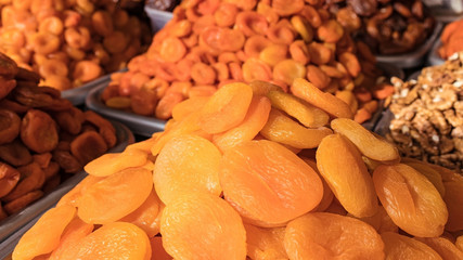  Various dried fruits and nuts on the counter of the Bazaar. Mix of different dried fruits sailing at a market.