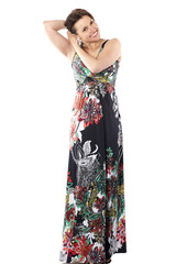 young beautiful woman in sundress with colorful flower pattern straightens his hair, looking at camera and smiling, full body portrait