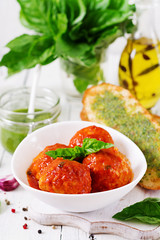 Meatballs in tomato sauce and toast with basil pesto. Dinner. Tasty food.