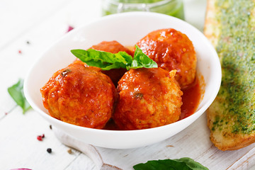 Meatballs in tomato sauce and toast with basil pesto. Dinner. Tasty food.