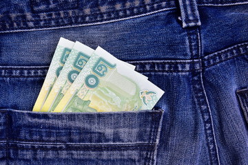 Thai money in the back pocket of jeans. Concept on a trip to Thailand. Concept on a trip to...