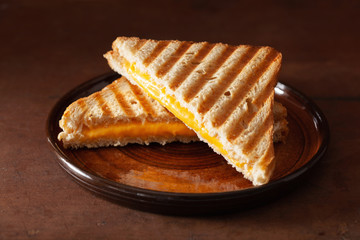 grilled cheese sandwich on rustic brown background