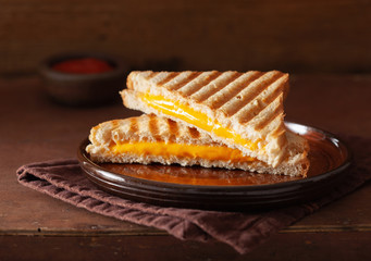 grilled cheese sandwich on rustic brown background