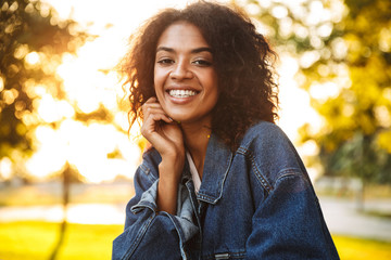Delighted young african girl in denim jacket
