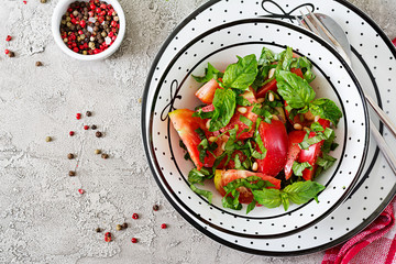 Tomato salad with basil and pine nuts in bowl - healthy vegetarian vegan diet organic food...
