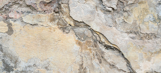 Old Wall With Peel Grey Stucco Texture. Retro Vintage Worn Wall Background. Decayed Cracked Rough Abstract Banner Surface.