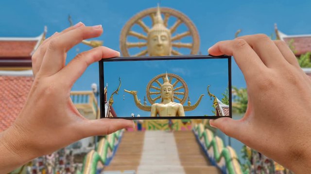 Cinemagraph of Taking Mobile Photo of Big Buddha Statue - Symbol and Main Landmark of Samui Island in Thailand. Tourism and Sightseeing