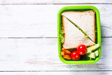 Lunch box with sandwich and vegetables. © nadianb