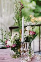 Wedding. Banquet. The festive table for guests, decorated with a composition of white and pink...