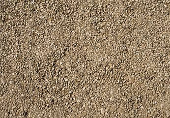 Texture of a gray concrete wall with small marble stones.