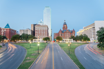 Dallas skyscrapers and light trail traffic over Dealey Plaza, JKF assassination site. Skyline and...